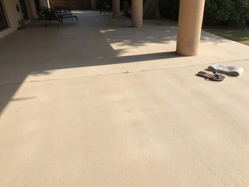Light-coloured cool-deck textured patio surface in bright sun